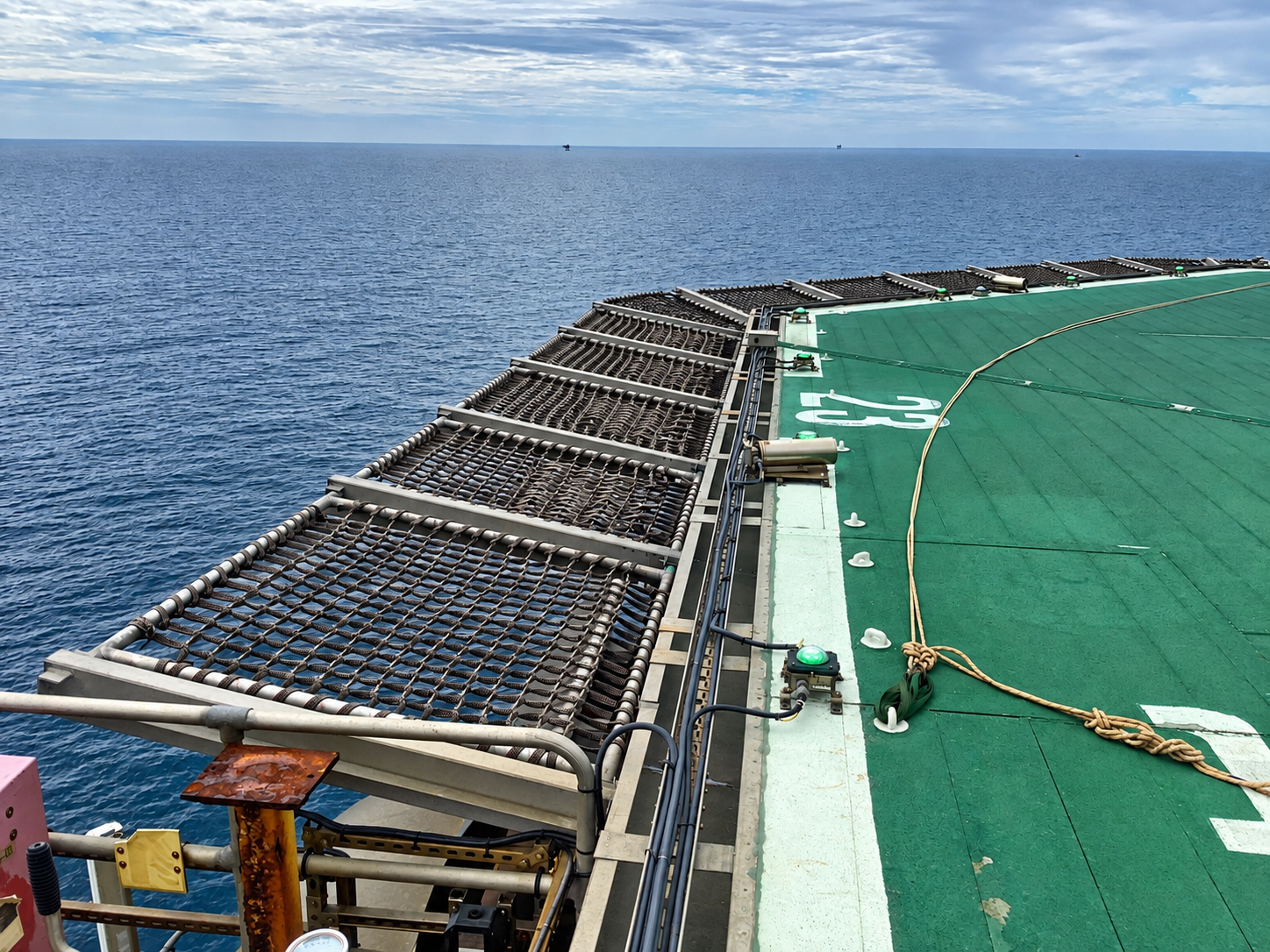 Helideck perimeter safety nets installed around an offshore helideck.